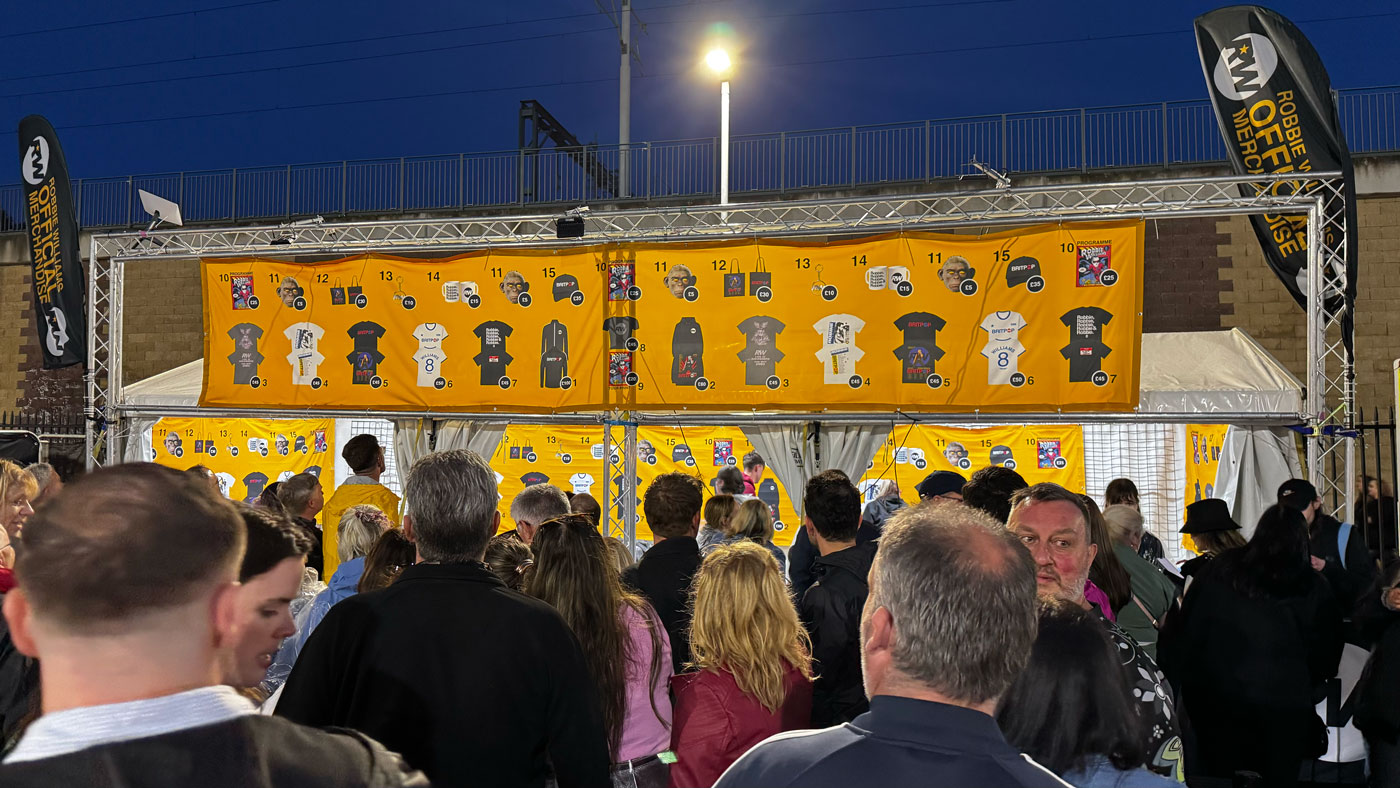 Robbie Williams Liverpool tour popup stand with audience queuing to buy merchandise