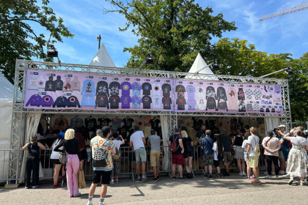 Long shot view of the Pink merch stand.