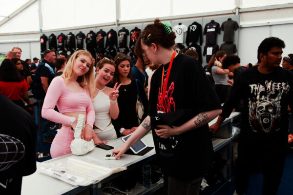 Fans buying and posing in The Weeknd merchandise shop