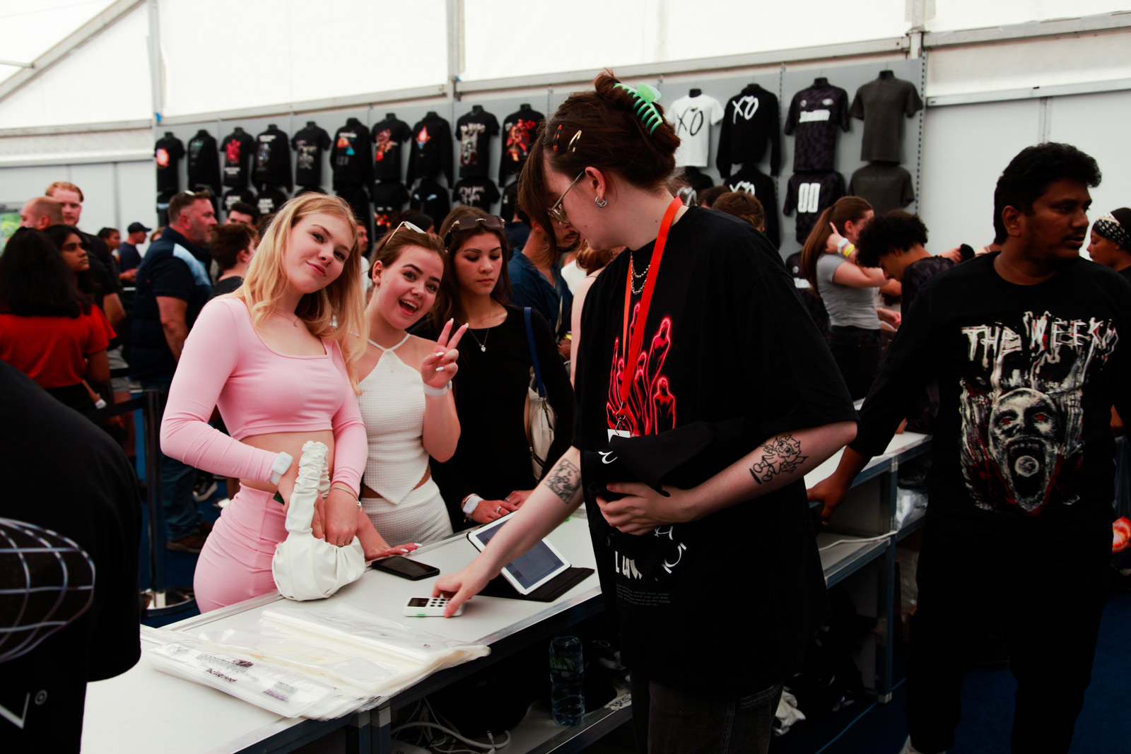 Fans buying and posing in The Weeknd merchandise shop