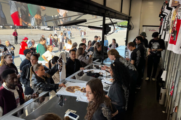 Inside view of Chris Brown stand with people selling merchandise.
