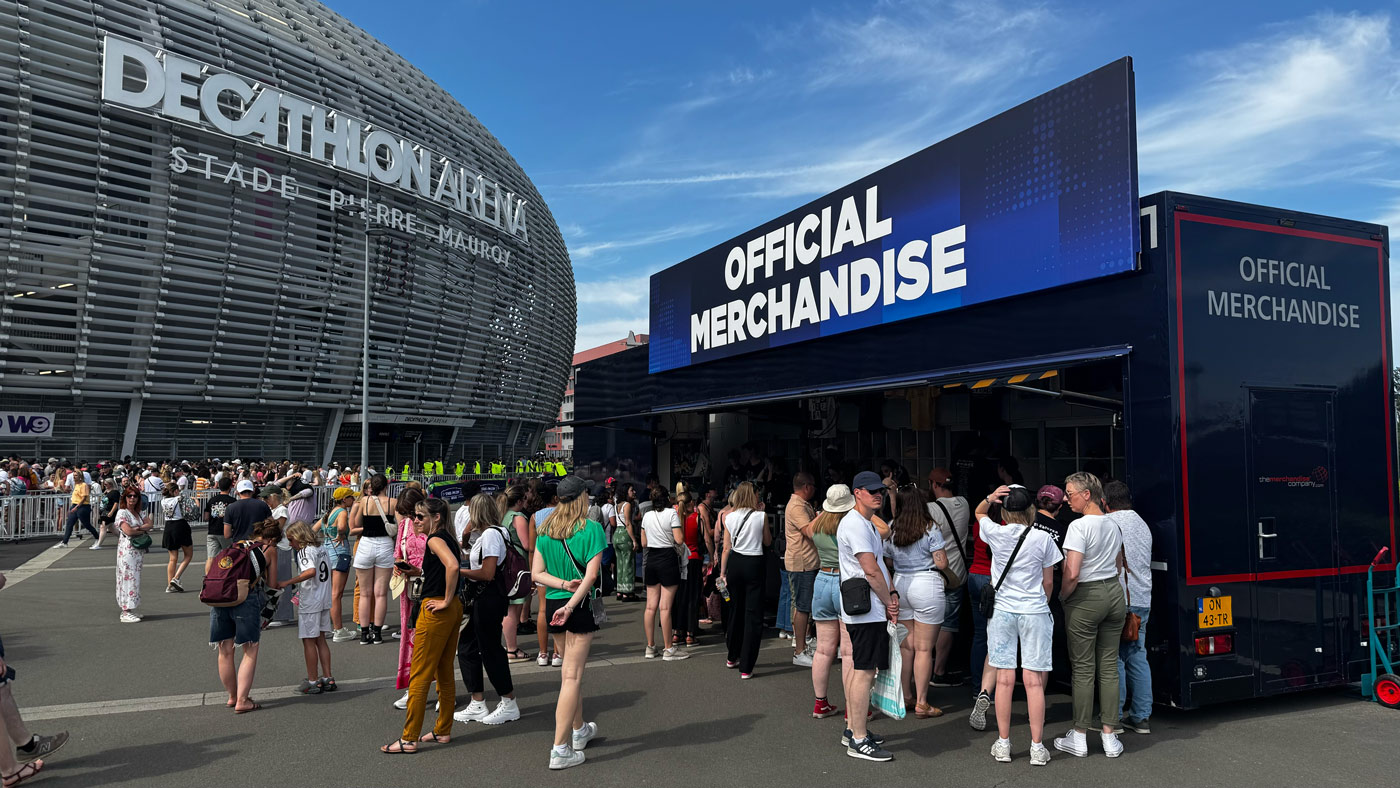 Audience Leaving the decathlon centre walking to the Ed Sheeran Merchandise stand.