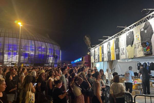 Audience queuing for Ed Sheeran merch stand.